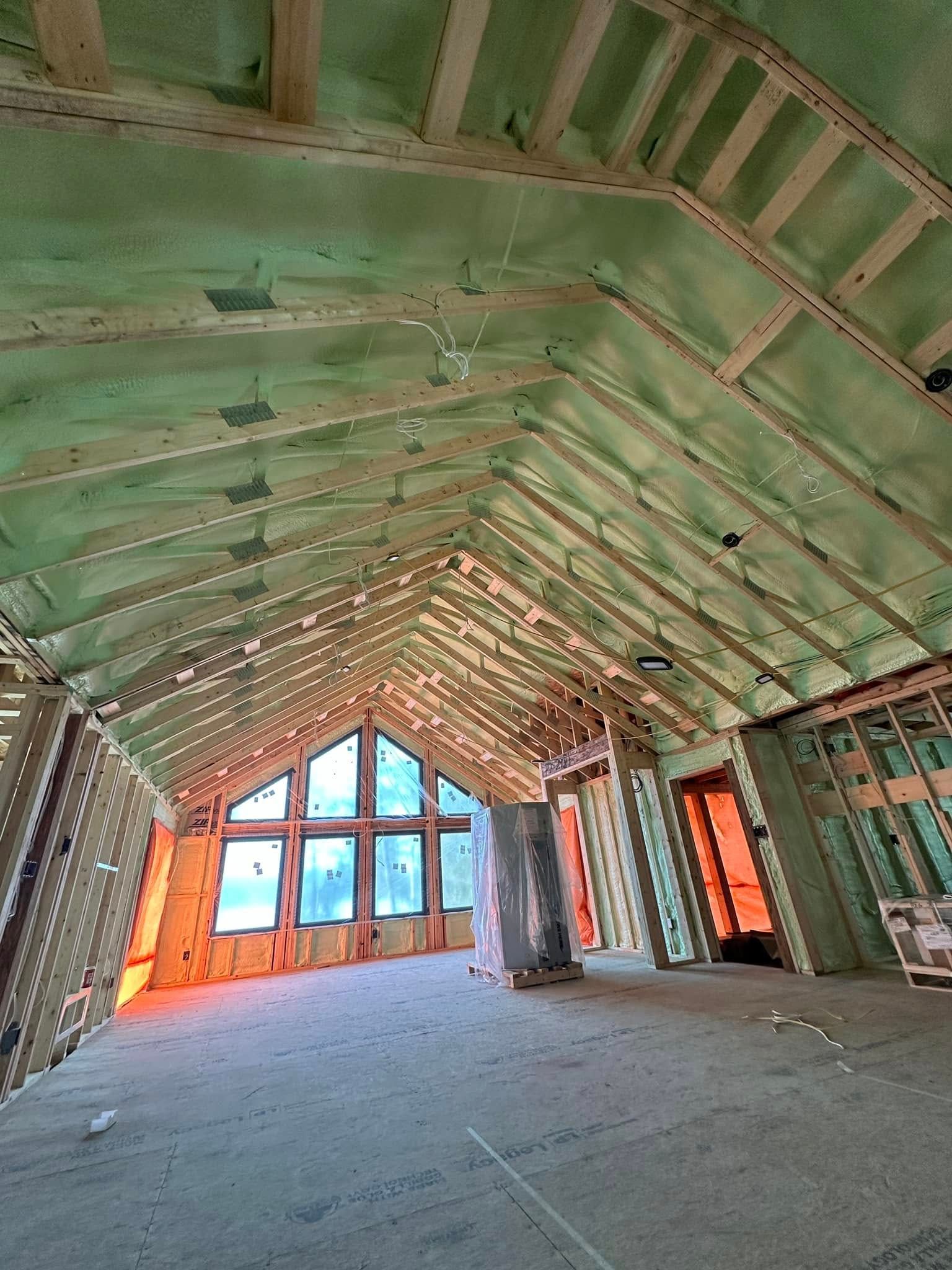 A large room with a green roof and a lot of windows.
