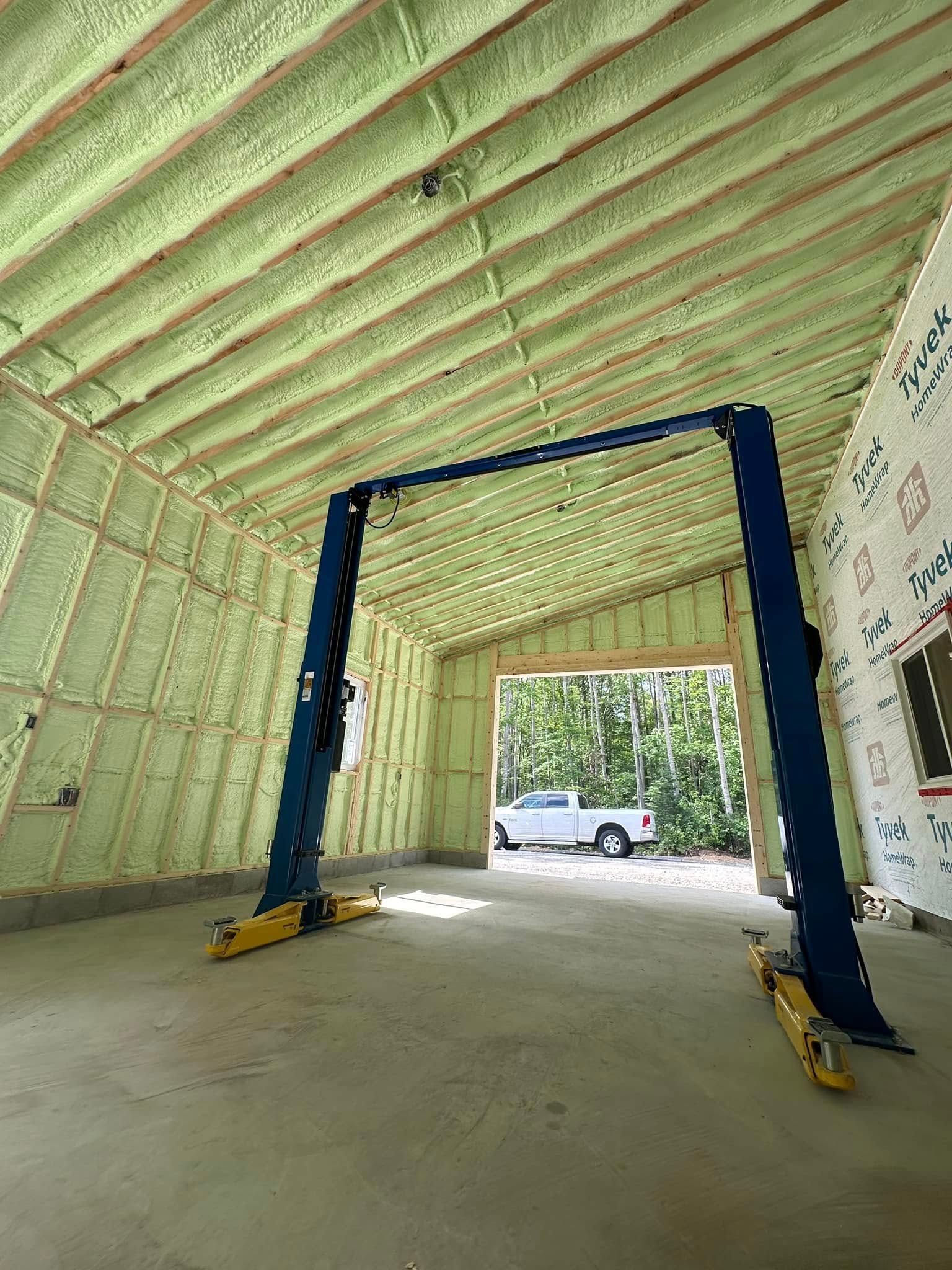 A garage with a lift in it and a truck parked in it.