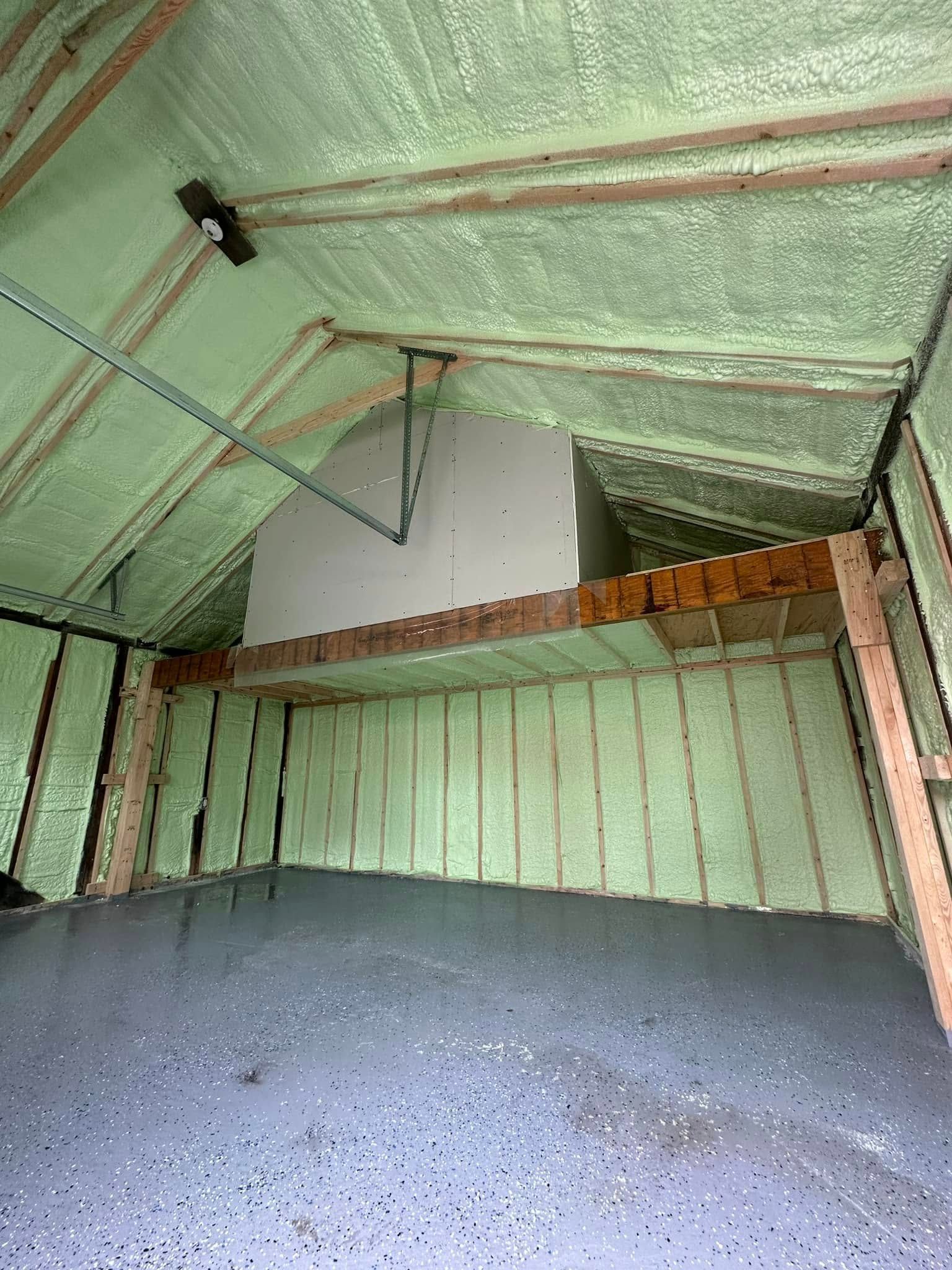 A garage with a lot of insulation on the walls and ceiling.
