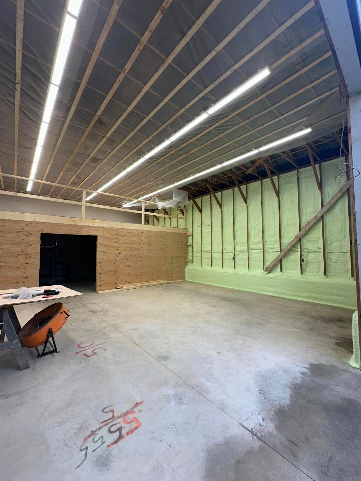 A large empty room with a table and a saw in it.