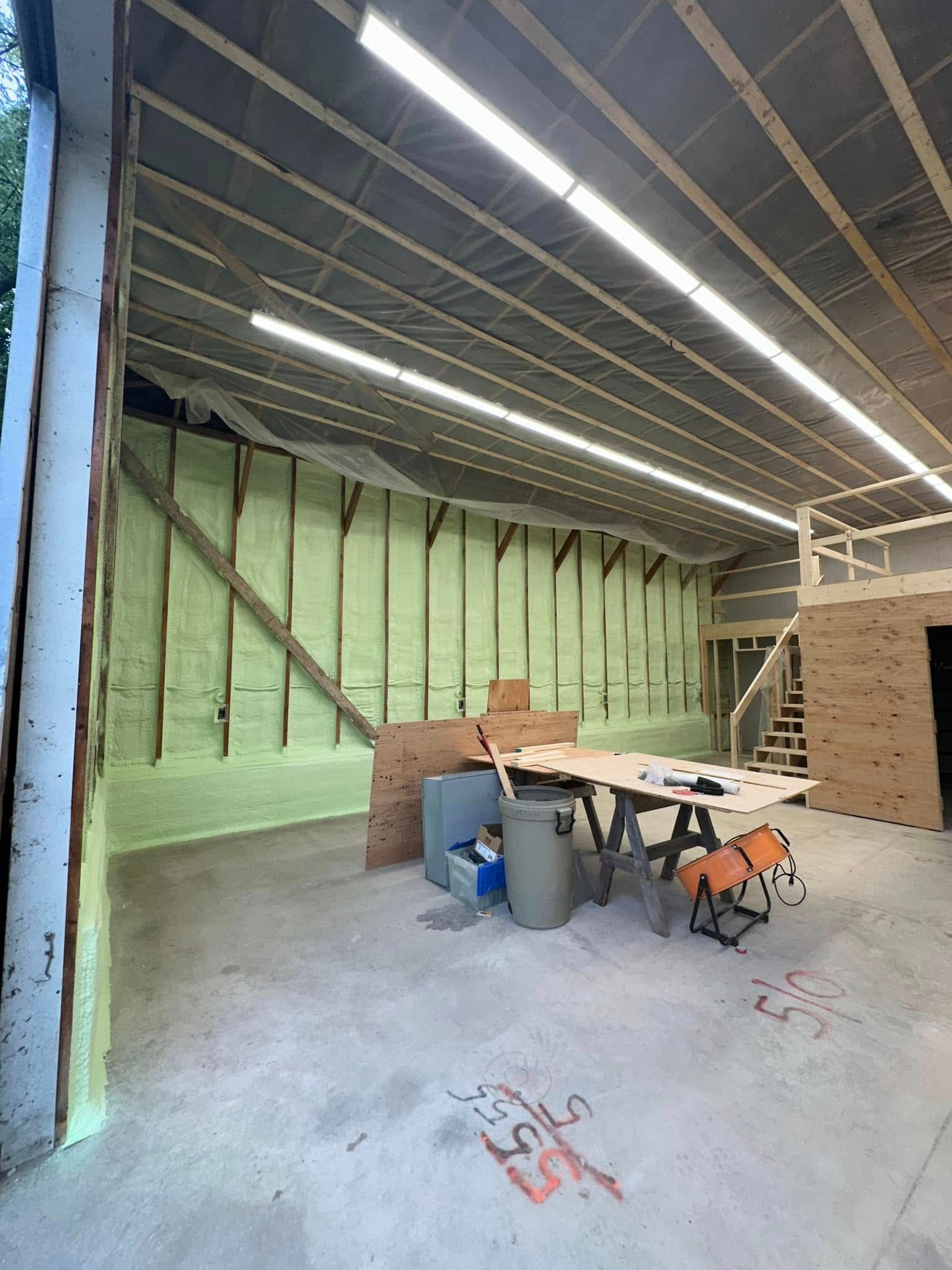 A large room with a table and chairs in it.