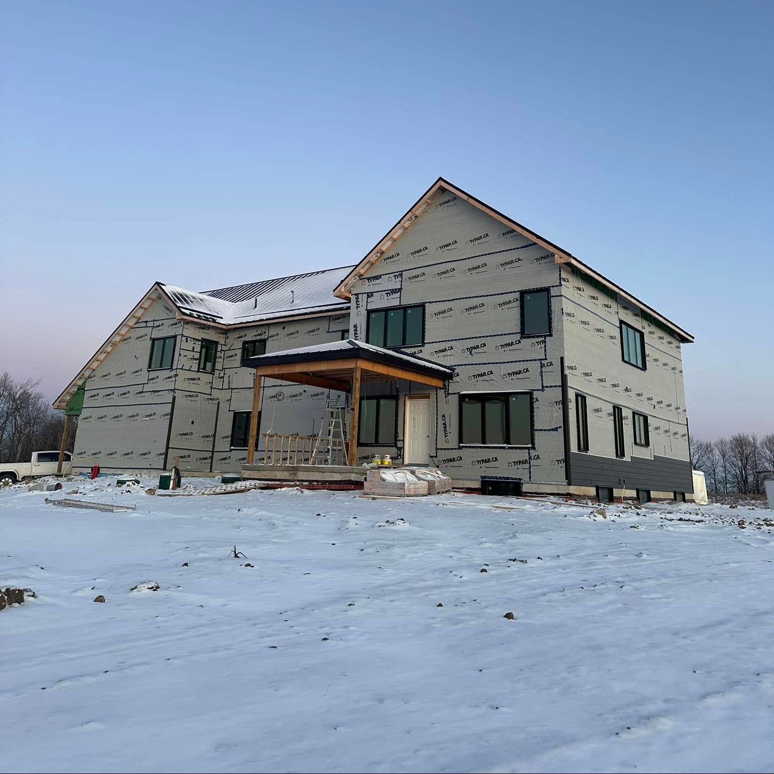A large house is being built in the snow