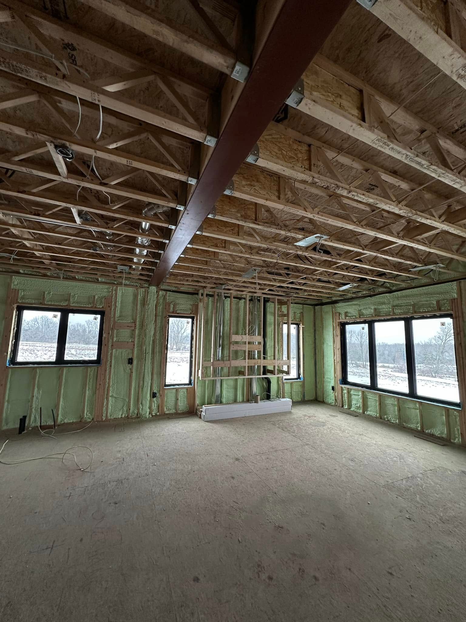 A large room with a lot of windows and a wooden ceiling.