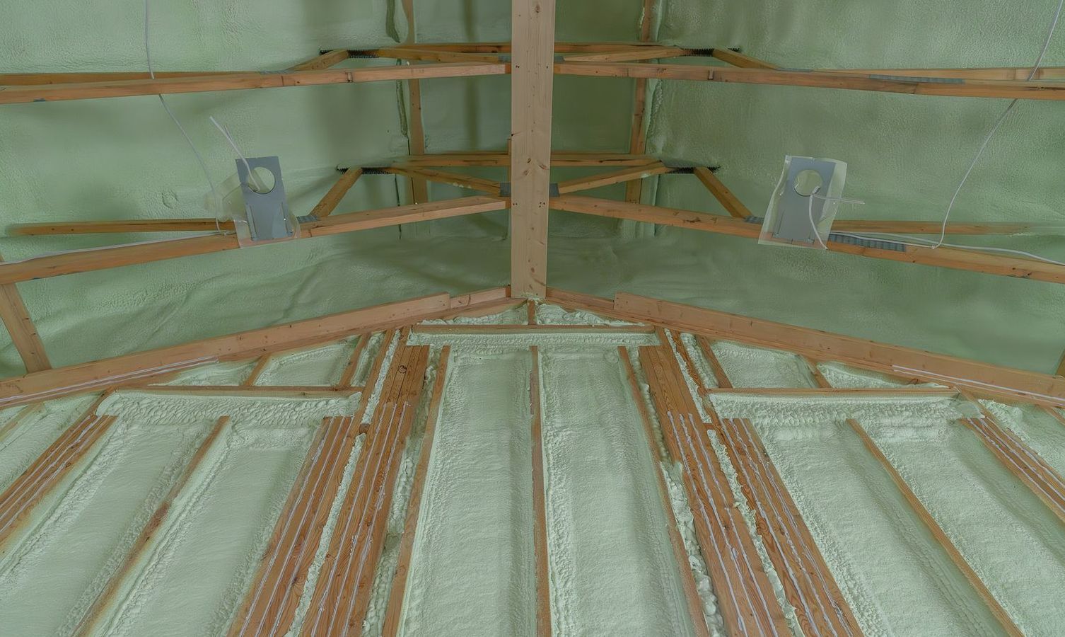 The ceiling of a building is covered in foam and wooden beams.