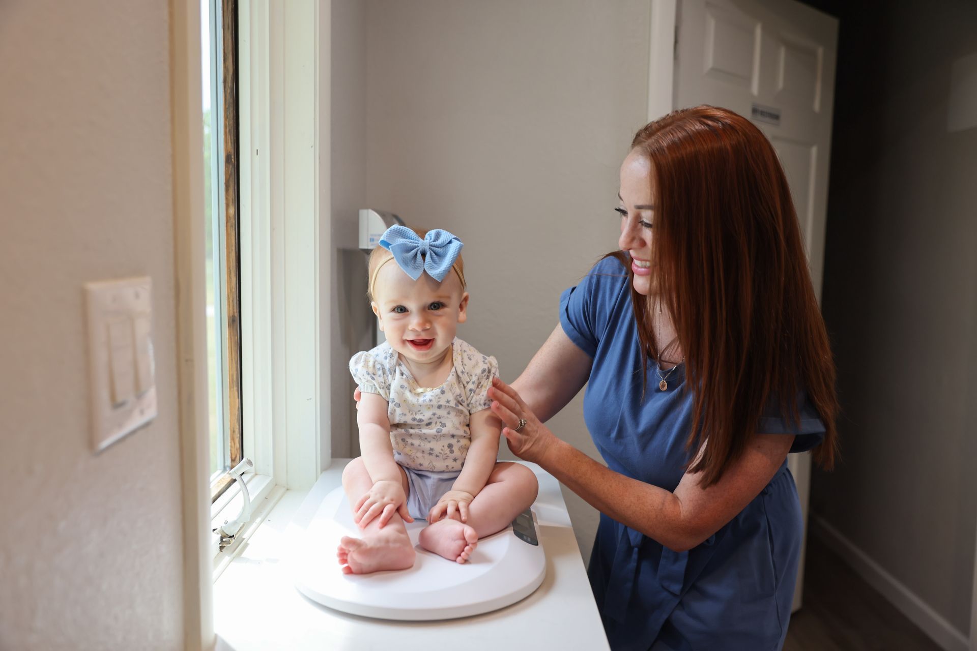 Pediatrician examining  a little girl