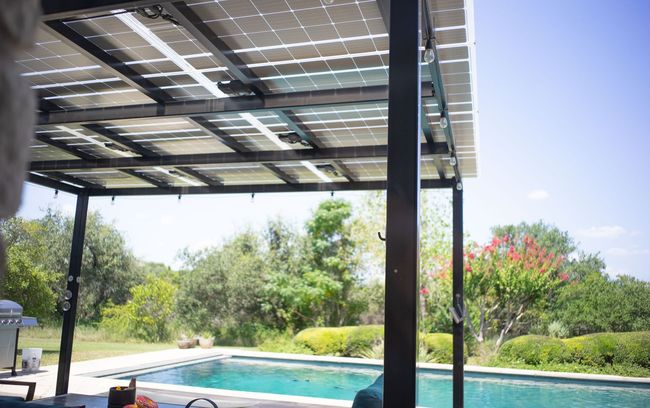 A Solar Panel Powered pergola with solar panels over a swimming pool.