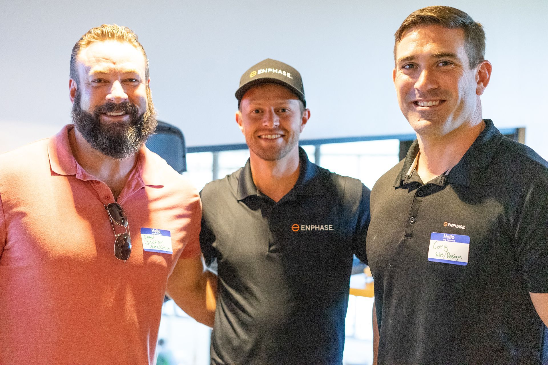 Three men are posing for a picture together in a room.