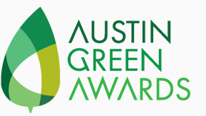 The logo for the austin green awards has a green leaf on it.