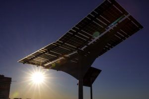 A large solar panel with the sun shining through it
