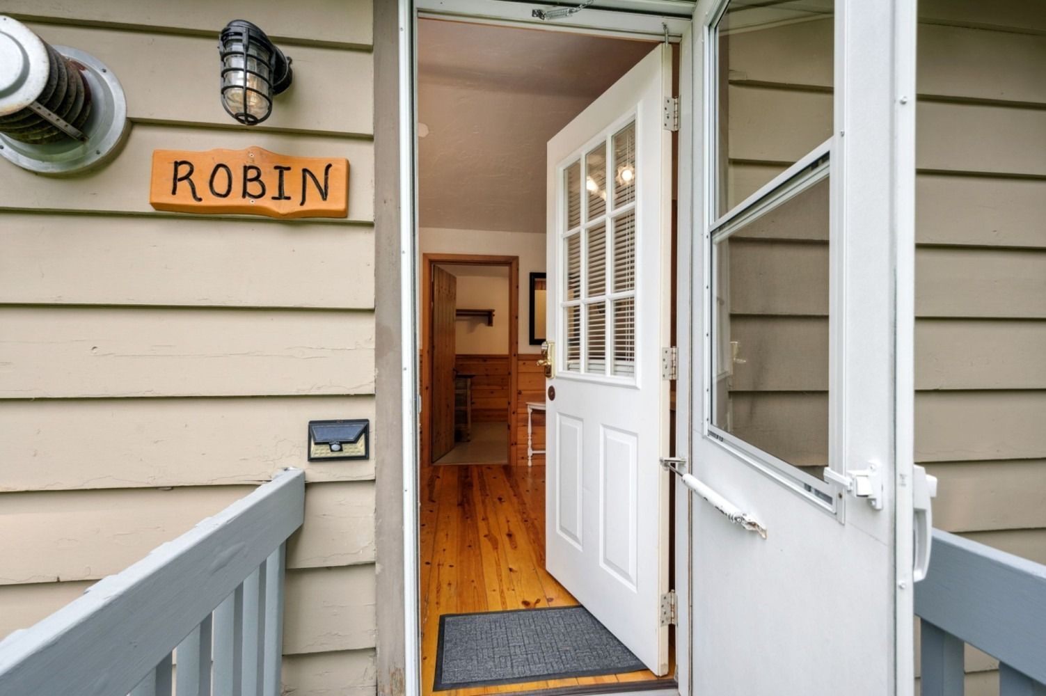 Open white door of a home with a 