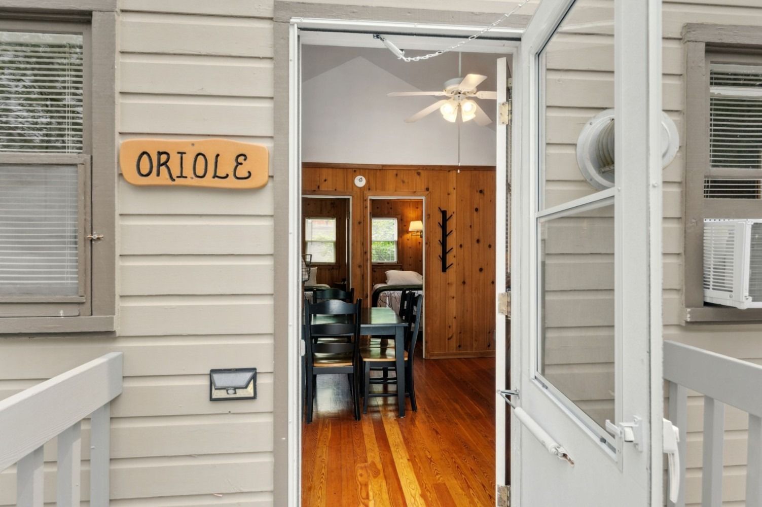 Exterior view of a cabin doorway labeled 