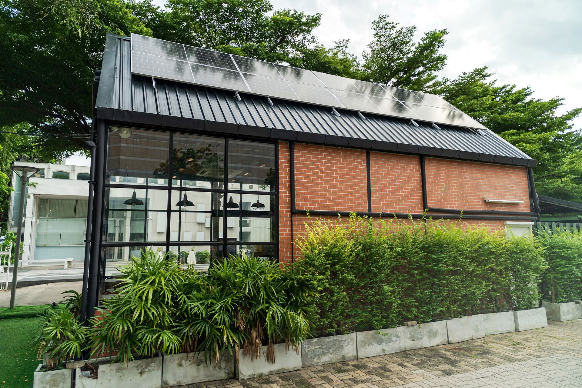 A small brick building with solar panels on the roof.
