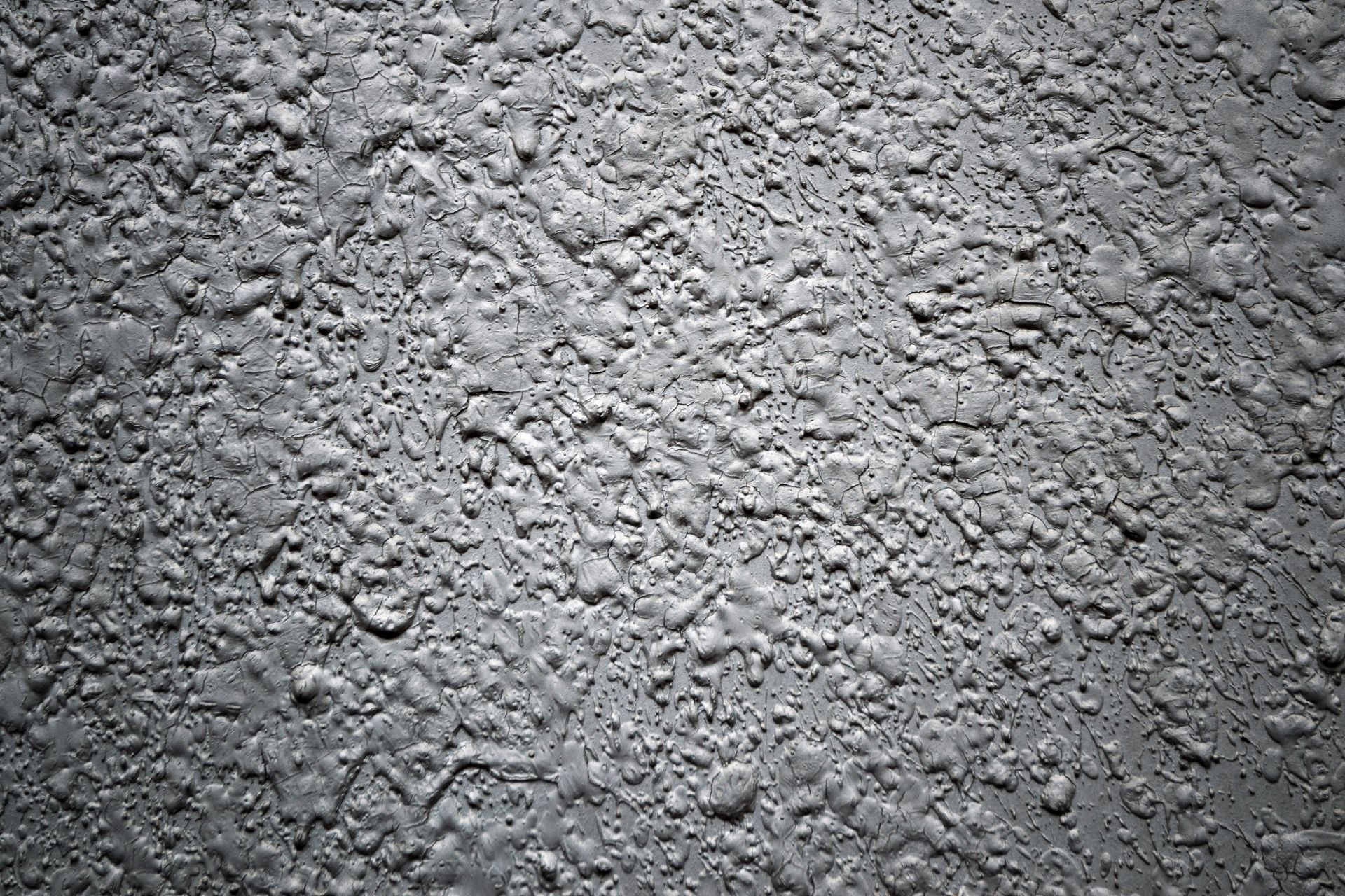 Close-up of rough textured concrete wall in black and white.
