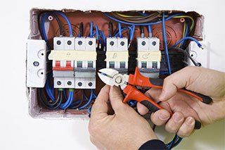 man working with electric panel