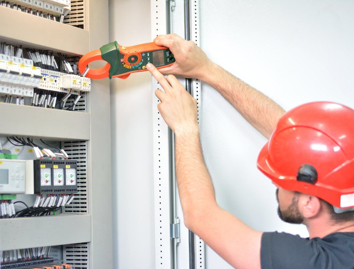 man working on electric panel