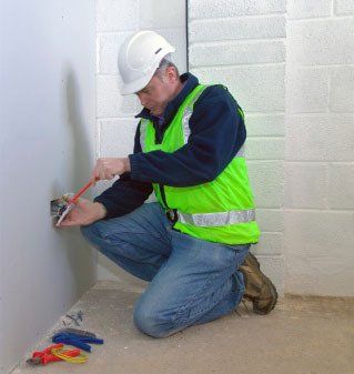 man working on electric outlet