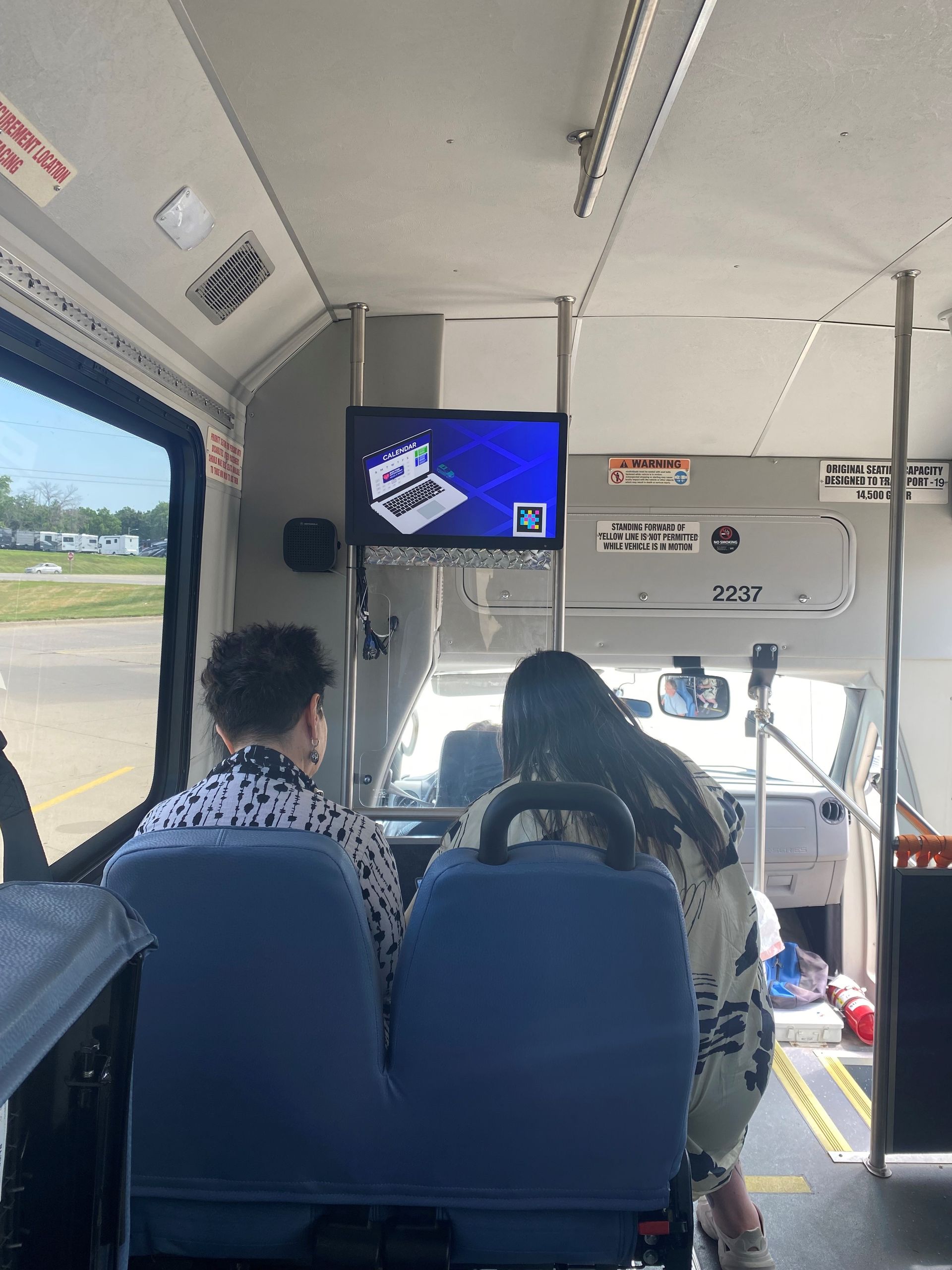 Two passengers sitting in a Health Connector bus.