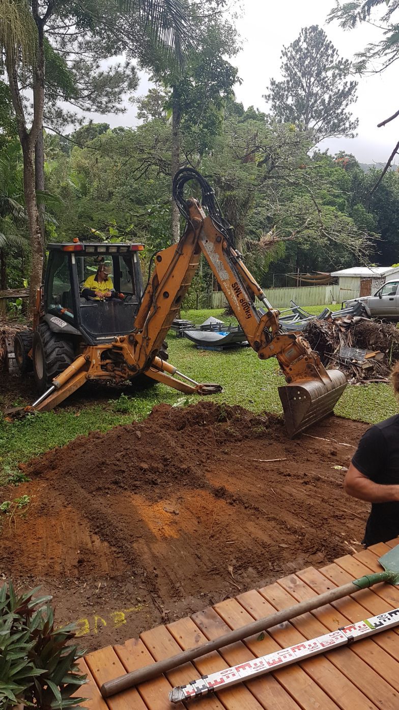 A Man Is Pumping Concrete with A Hose on A Construction Site — Bunker FNQ in Kuranda, QLD