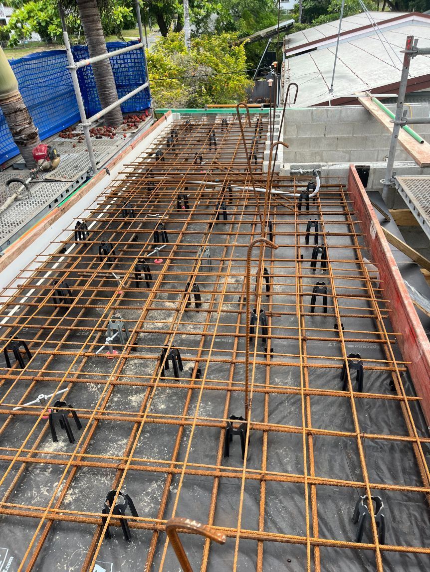 A Man Is Working on A Concrete Surface with A Broom — Bunker FNQ in Kuranda, QLD