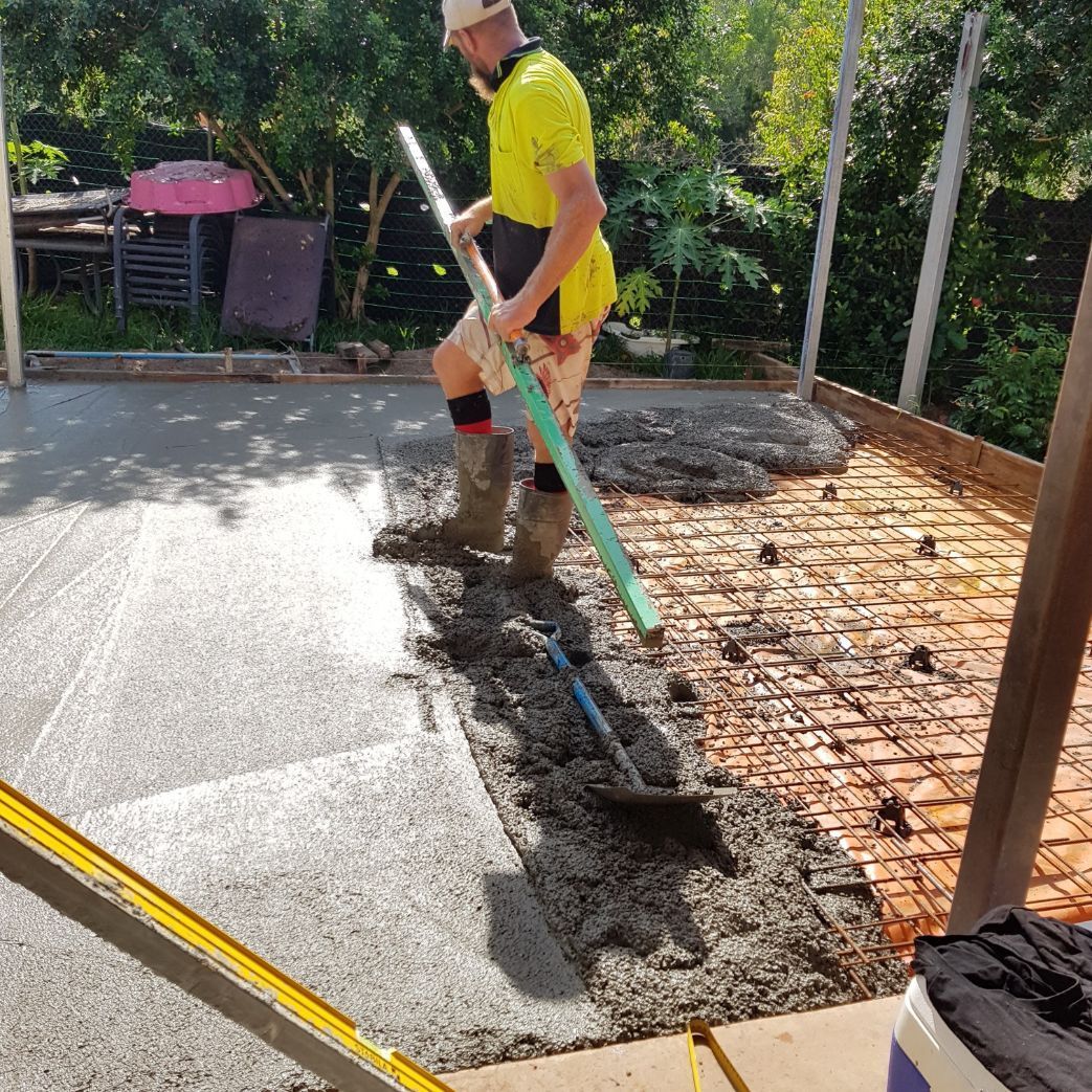 A Group of Construction Workers Are Working on A Concrete Floor — Bunker FNQ in Kuranda, QLD