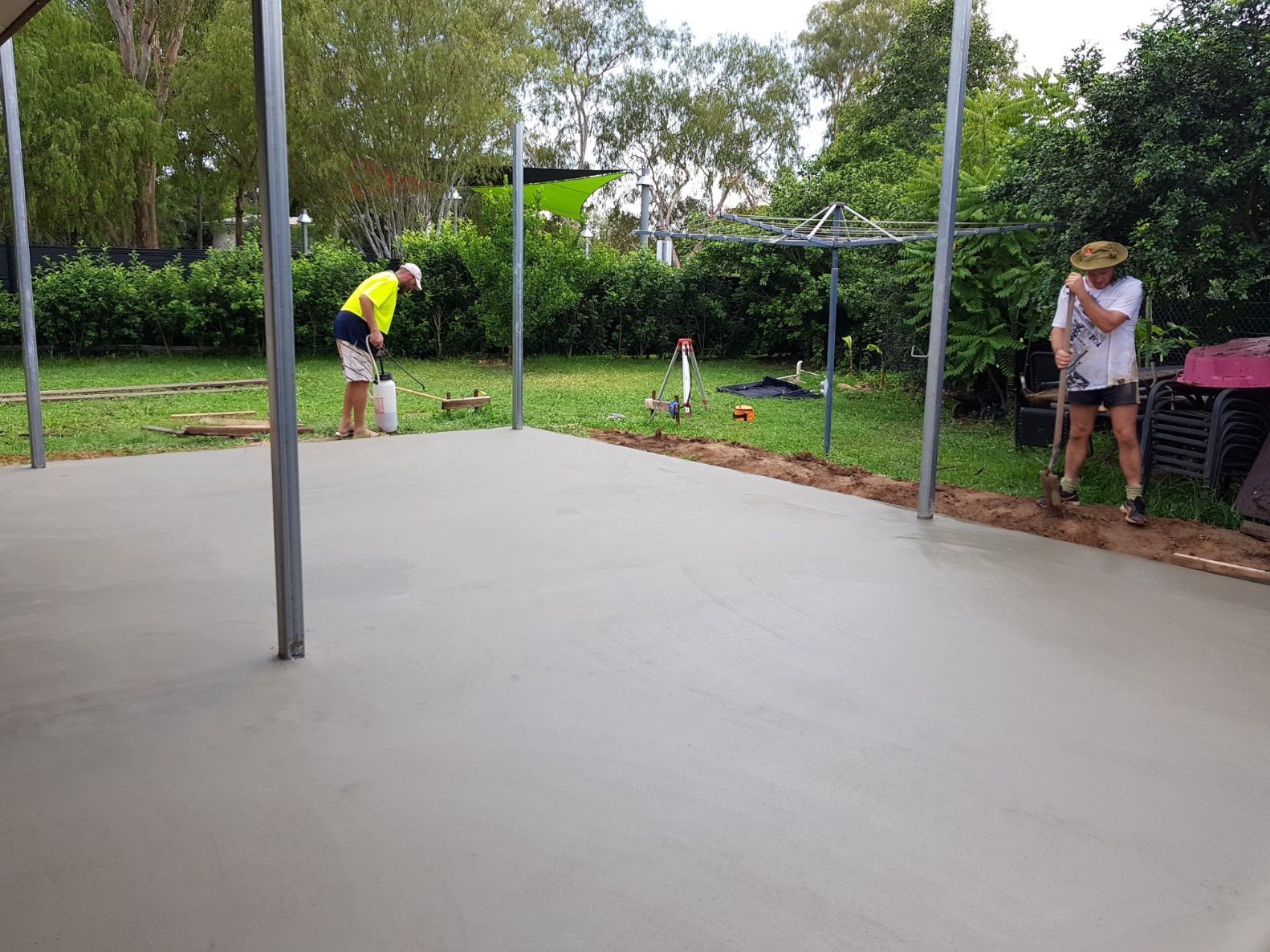 Two Construction Workers Are Working on A Concrete Floor — Bunker FNQ in Kuranda, QLD