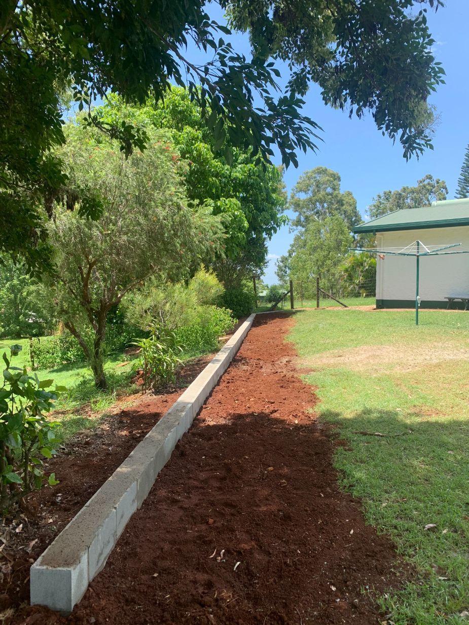 A Man Is Pouring Concrete on A Sidewalk with A Pump — Bunker FNQ in Redlynch, QLD