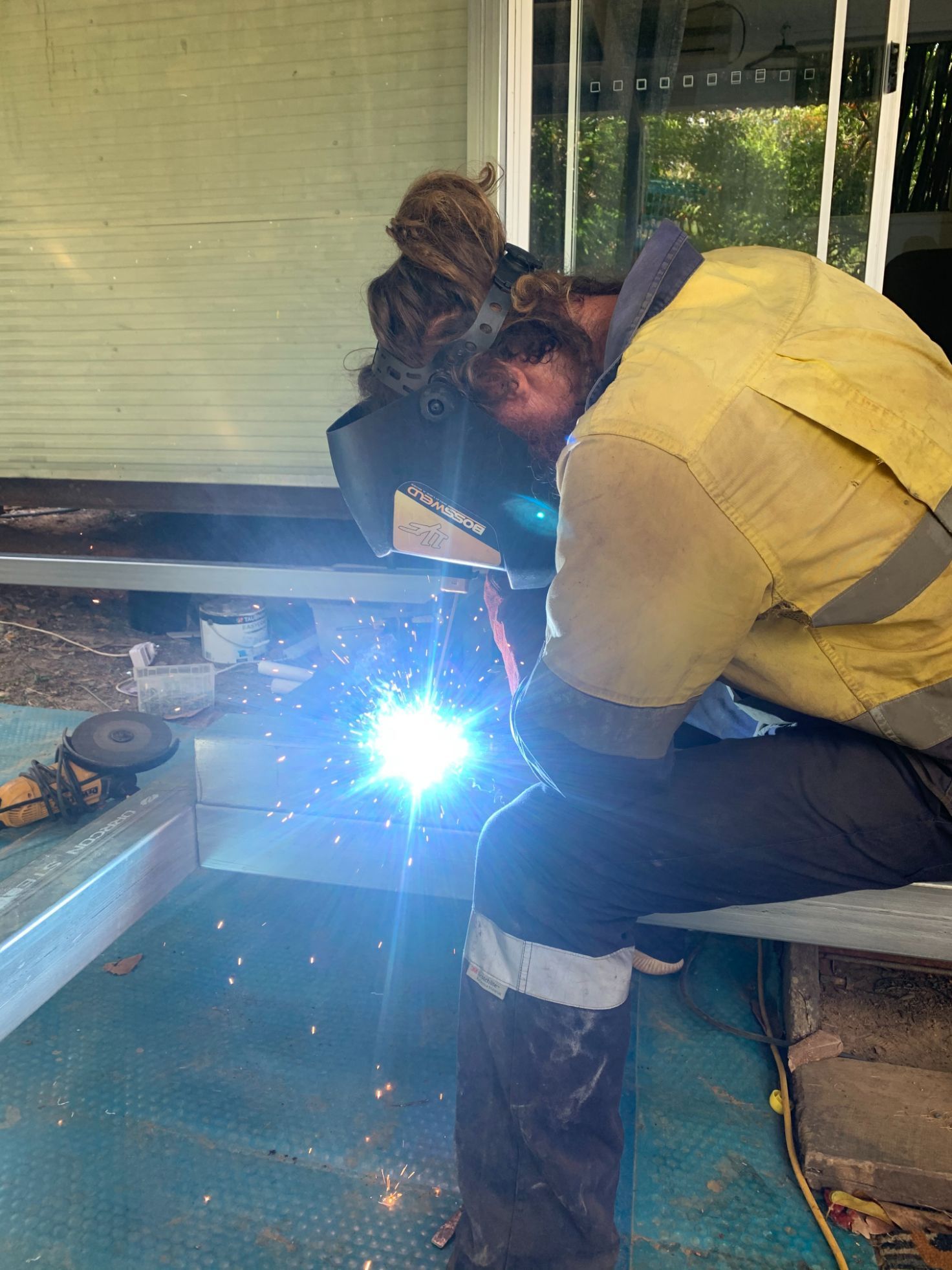 A Man Is Pouring Concrete Into a Pile of Dirt — Bunker FNQ in Kuranda, QLD