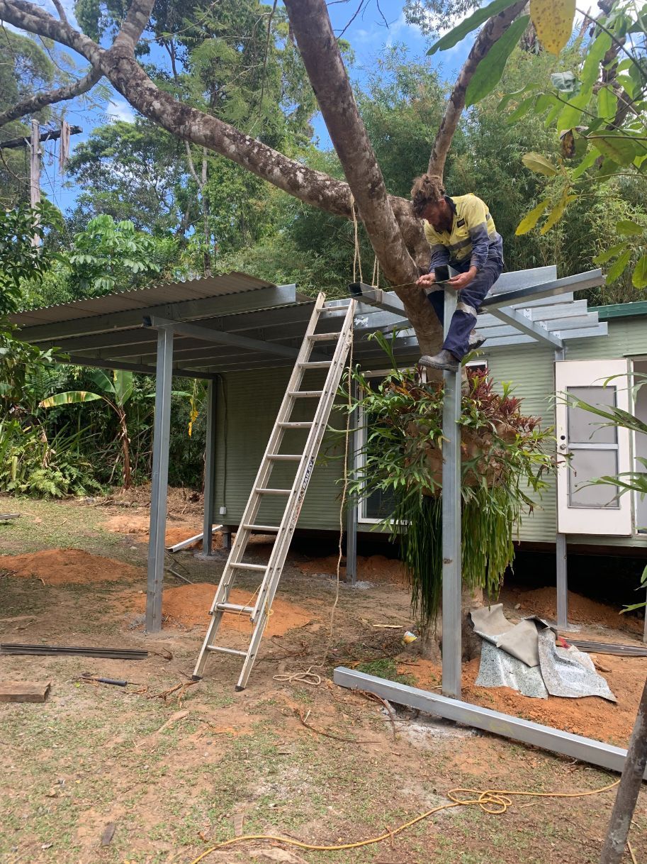 A Person Is Pouring Concrete Into a Grid with A Shovel — Bunker FNQ in Port Douglas, QLD