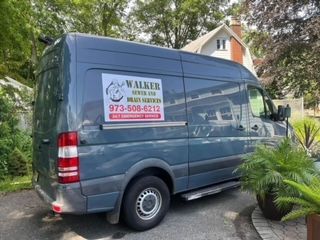 A walker van is parked in front of a house