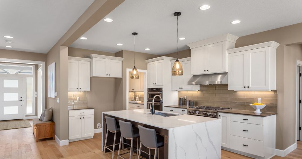 A kitchen has white marble benches and two hanging lights — SEP Electrical Pty Ltd in Albion Park, NSW