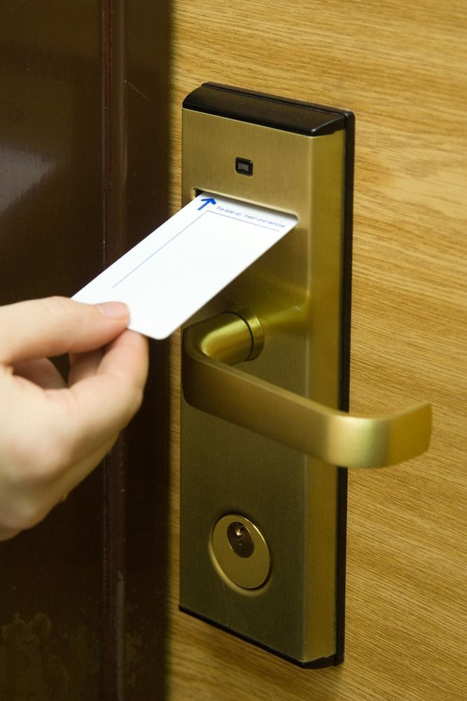 A Person is Inserting a Card Into a Door Lock — SEP Electrical Pty Ltd in Towradgi, NSW