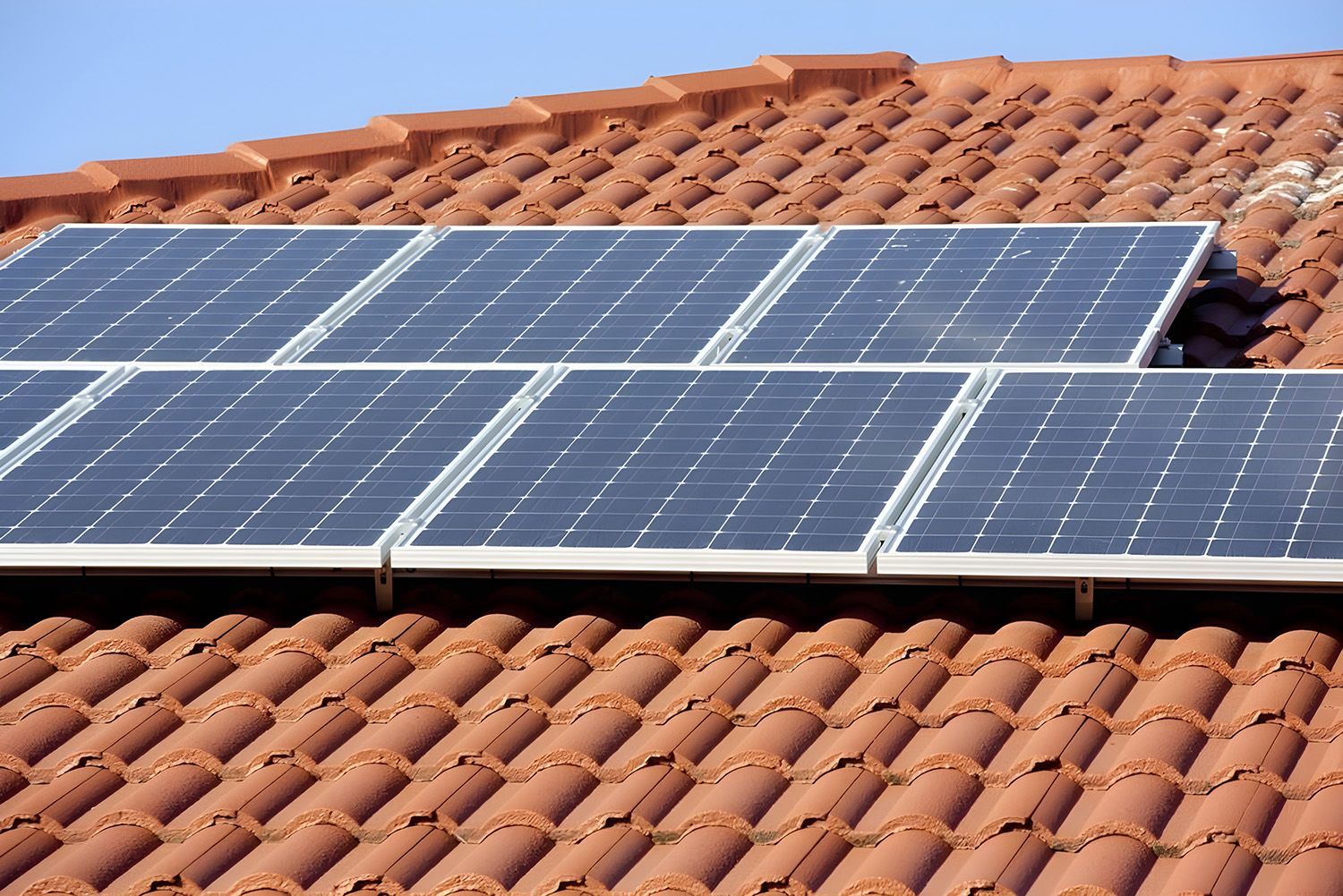Solar Panels Installed On A Terracotta-Tiled Residential Roof