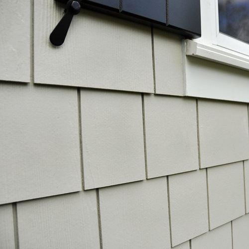 A close up of a siding on a house with a window