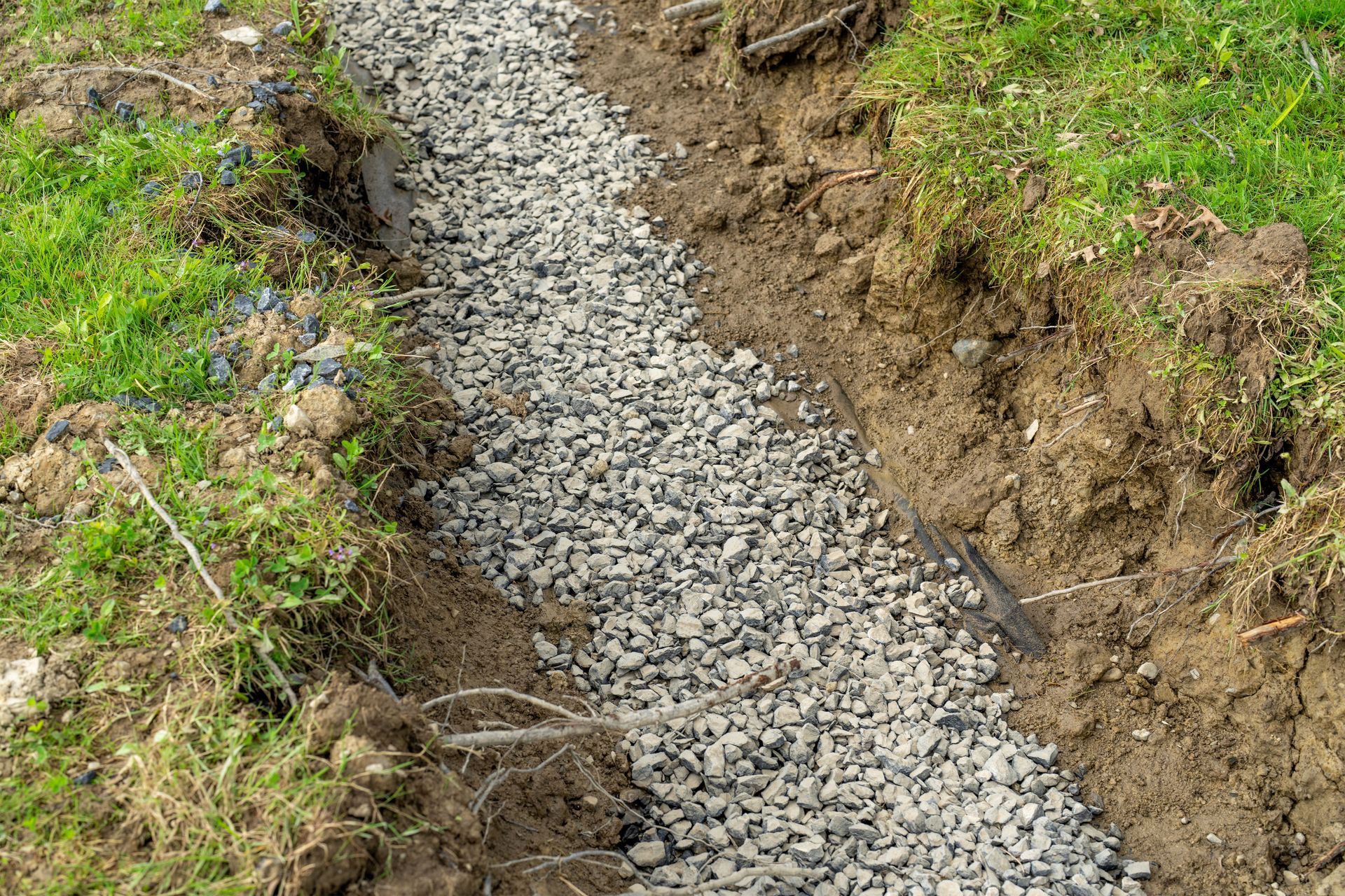 A gravel path is being built in the grass.