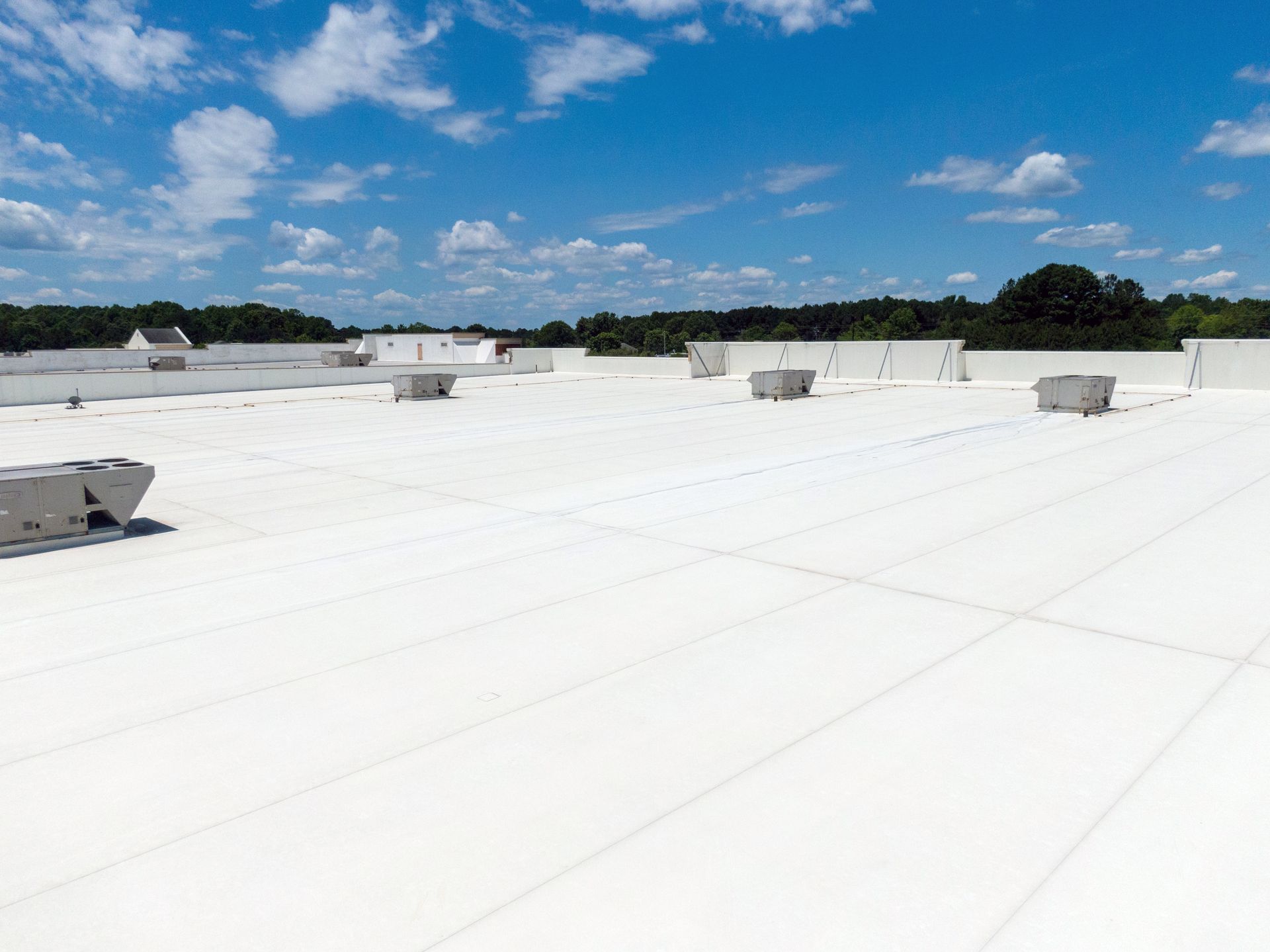 A large white roof with a blue sky in the background.