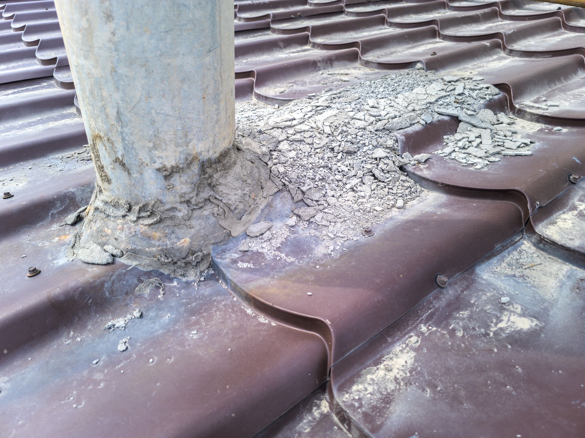 A chimney is sitting on top of a roof that is deteriorating