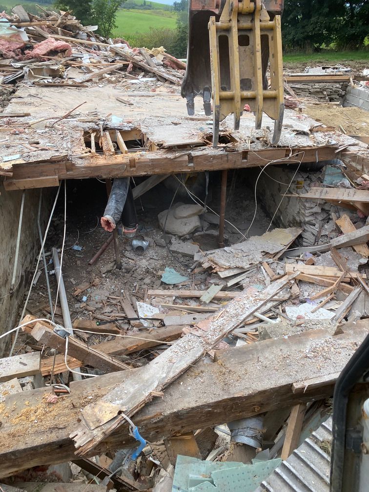 A person is standing in the middle of a pile of rubble.