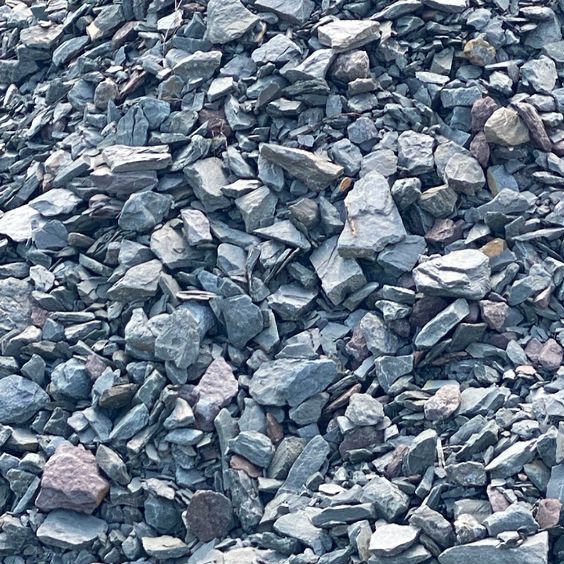 A pile of rocks is sitting on the ground.