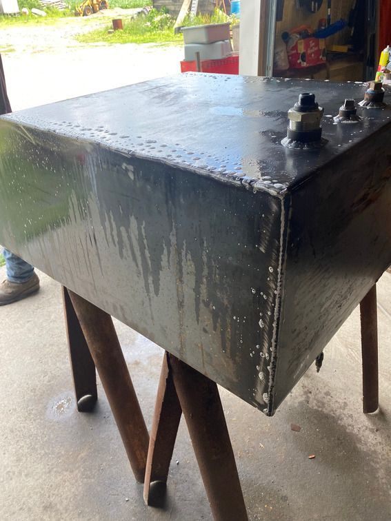 A large metal box is sitting on a wooden table