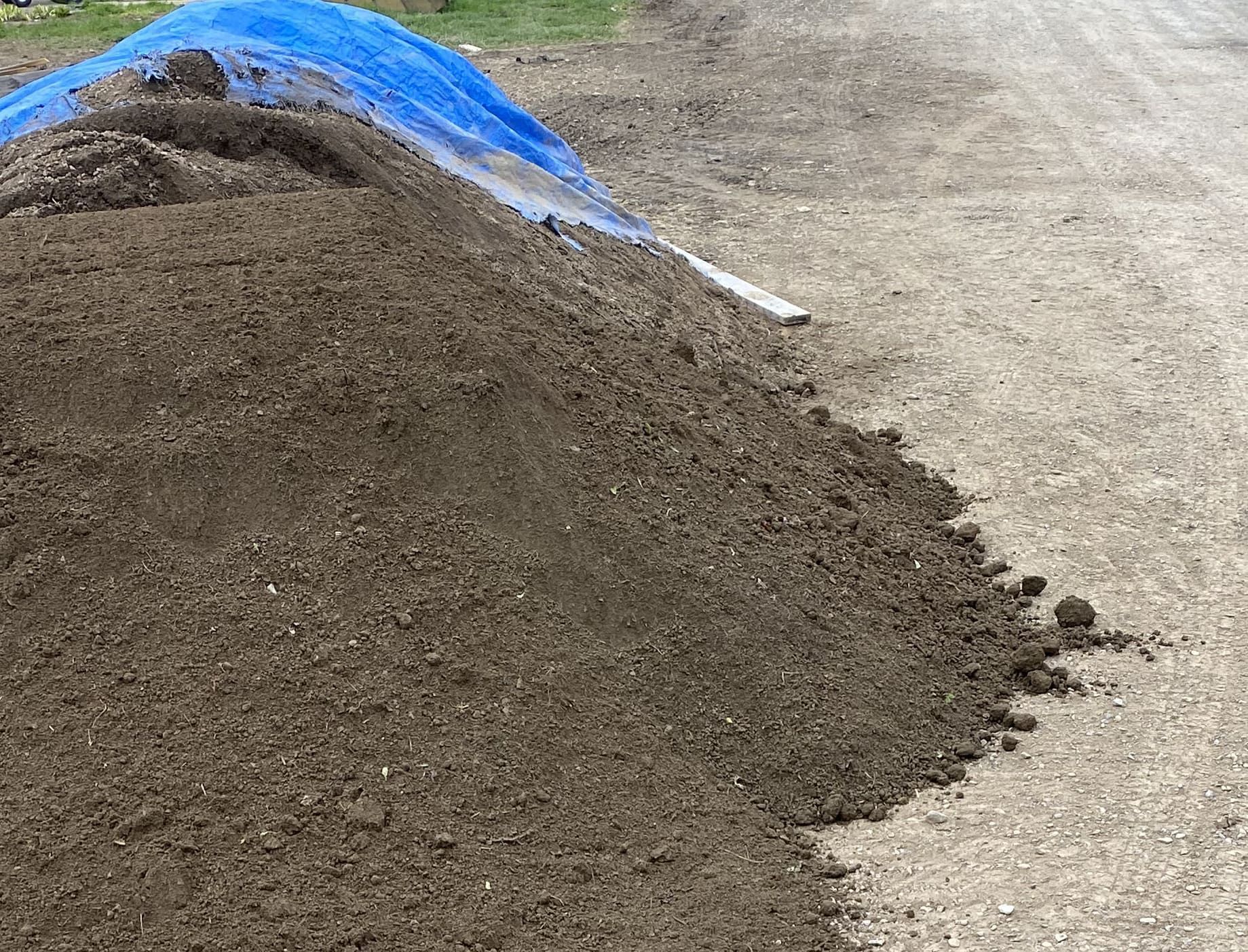 A pile of dirt is sitting on the ground.