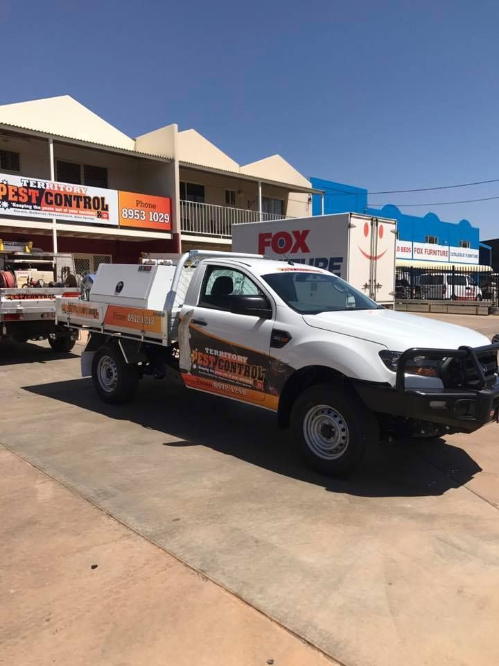A Vehicle with Business Signage in Front of a Store — Territory Pest Control In Winnellie, NT