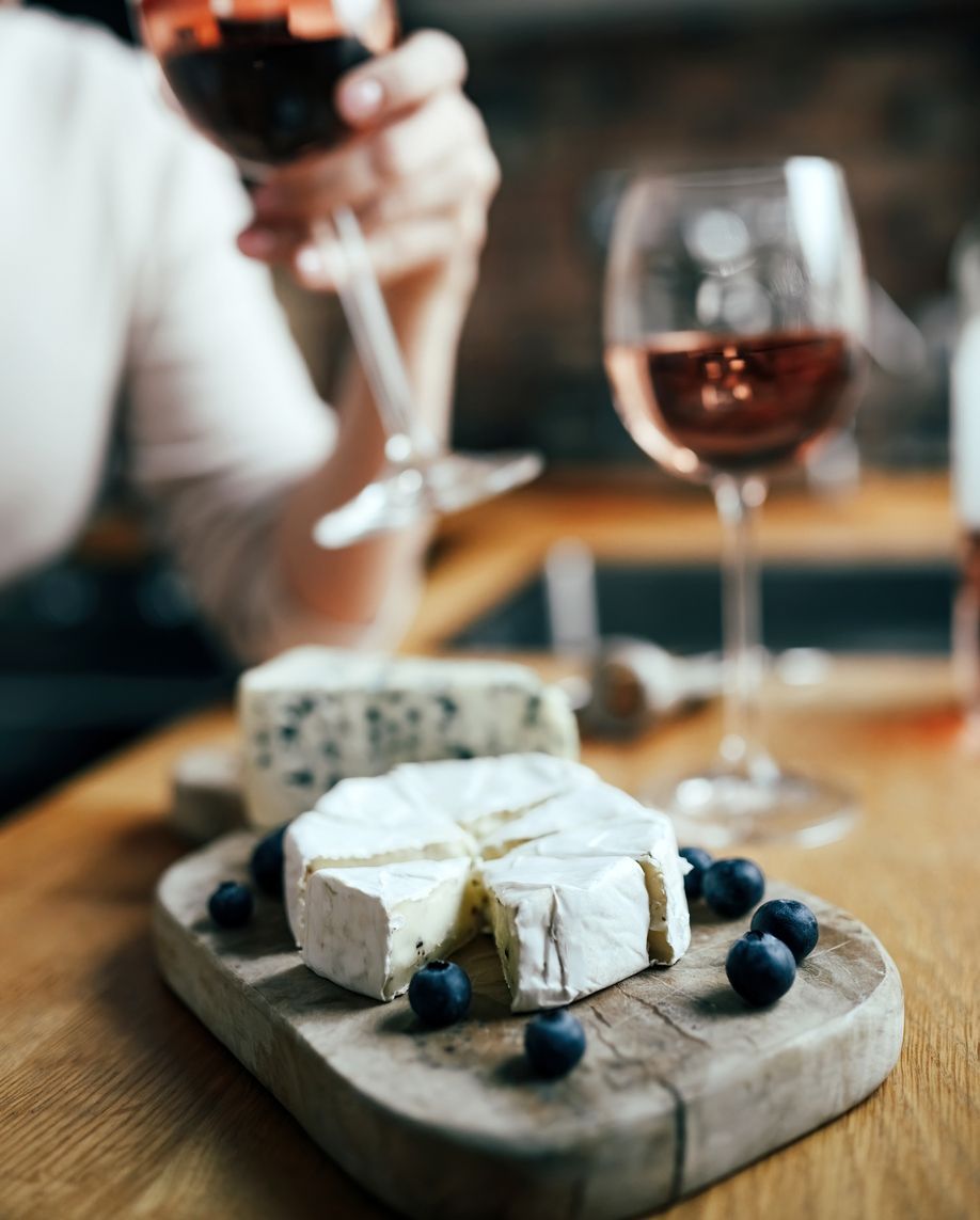 Women drinking a rose wine with french brie cheese 