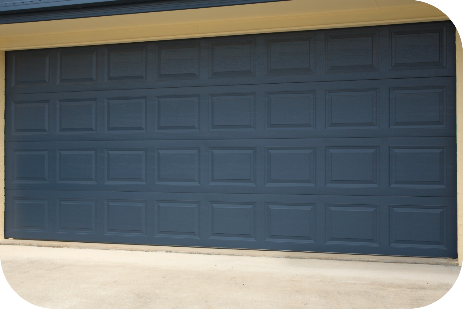 A dark blue, four-panel residential garage door with a traditional raised square grid pattern.