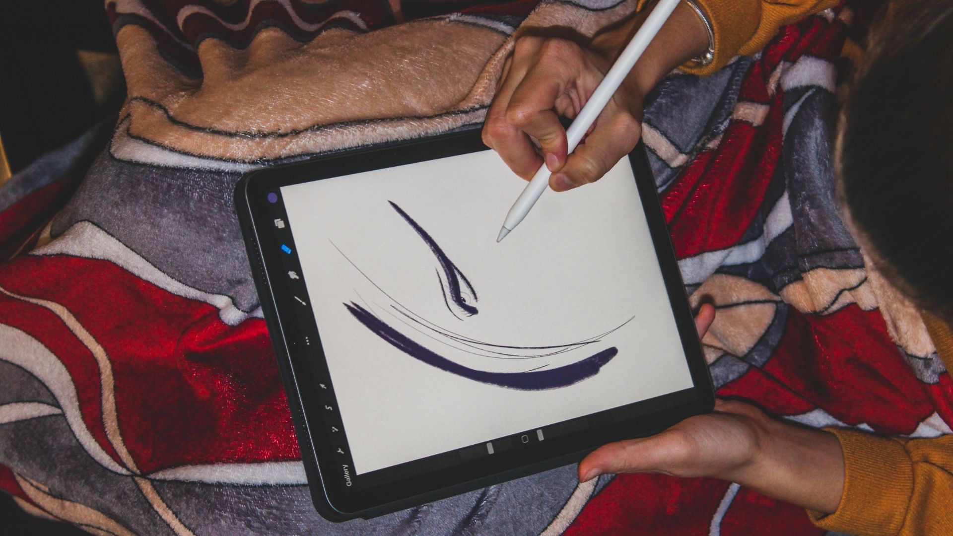 A marketer sitting down to work on digital branding on an ipad with pen
