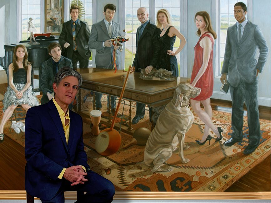John Varriano seated in front of a commissioned oil painting of an affluent family