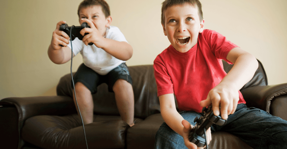 Two brothers playing on a games console