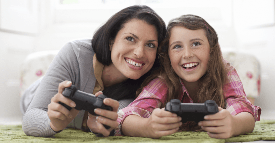 A mother and daughter playing on a games console