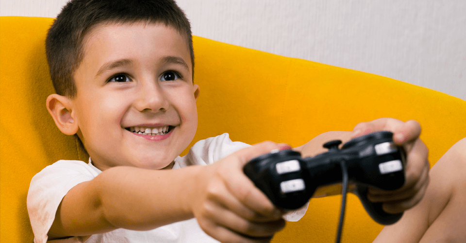 A little boy playing on a games console