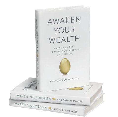 A stack of books titled awaken your wealth