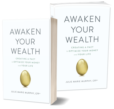 Two copies of the book awaken your wealth are sitting next to each other.